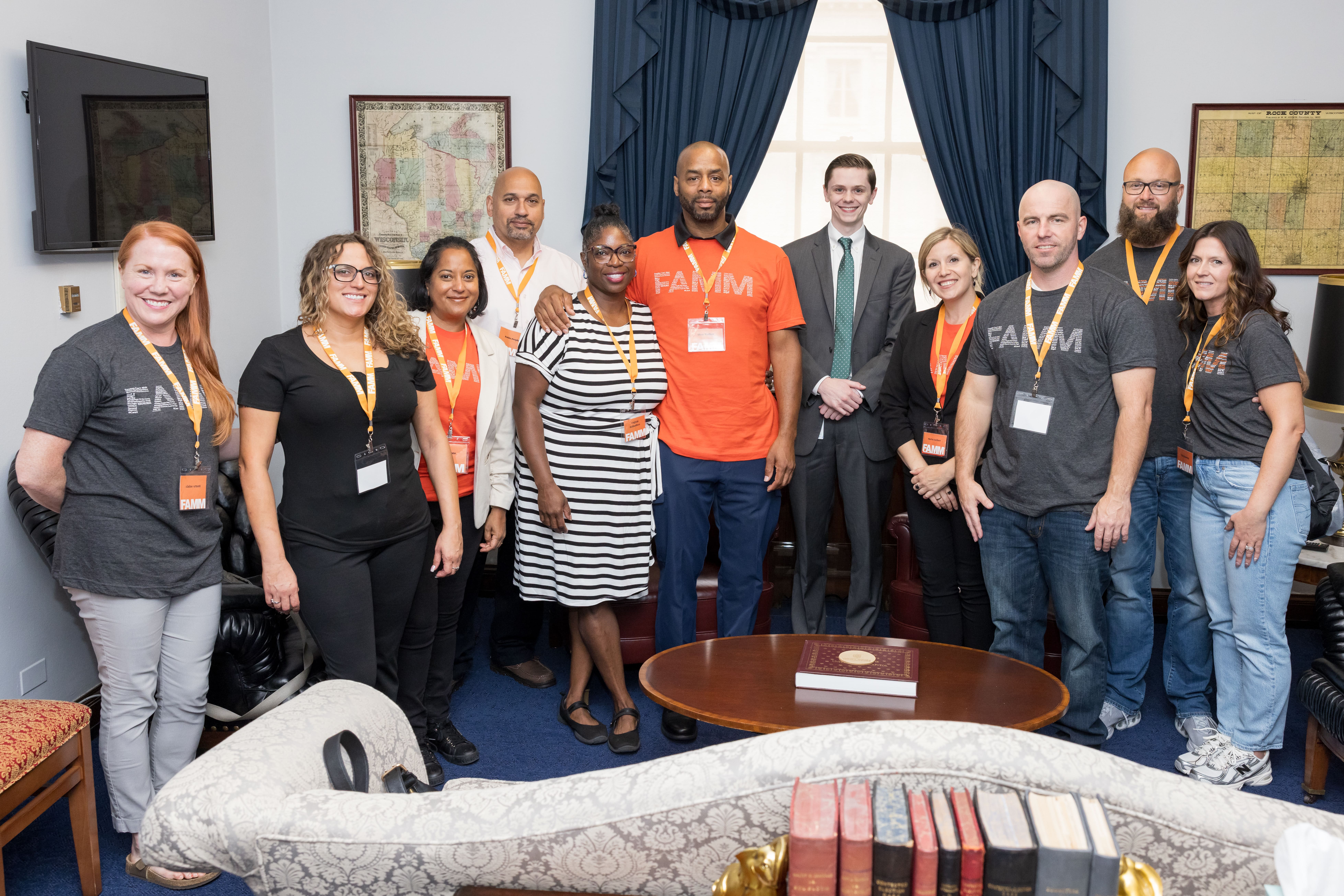 Group of advocates wearing FAMM badges gathered in an office during a meeting on Capitol Hill.